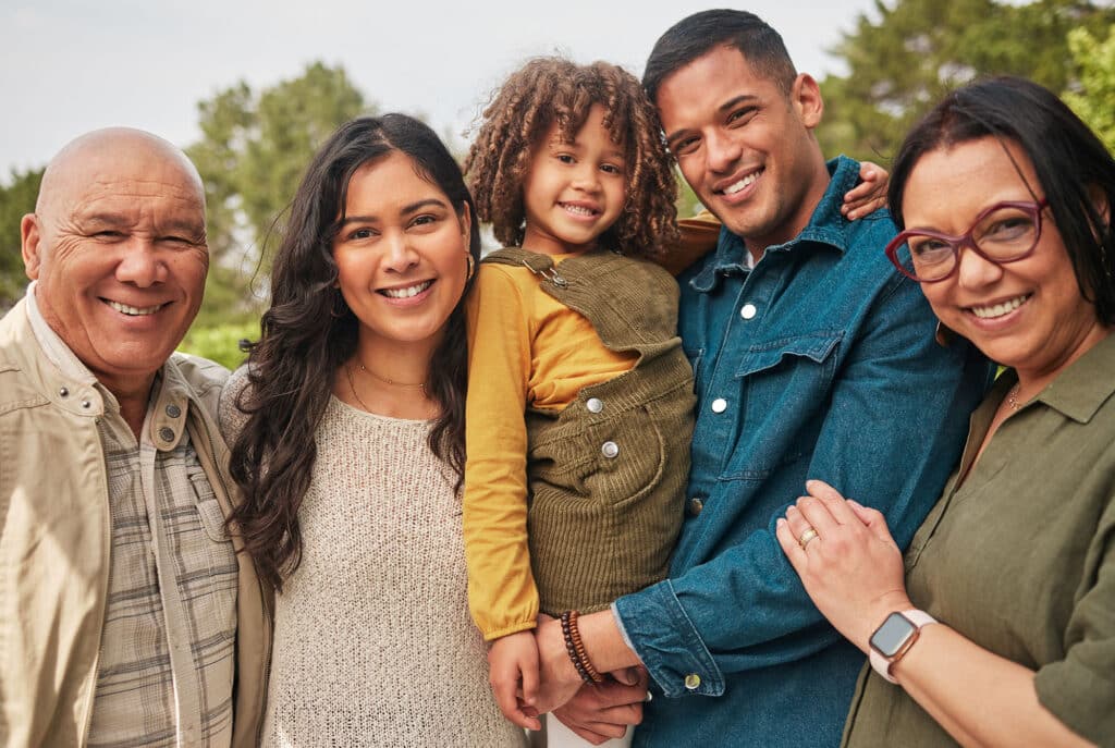 Happy family, grandparents and parent with kid in a park togethe