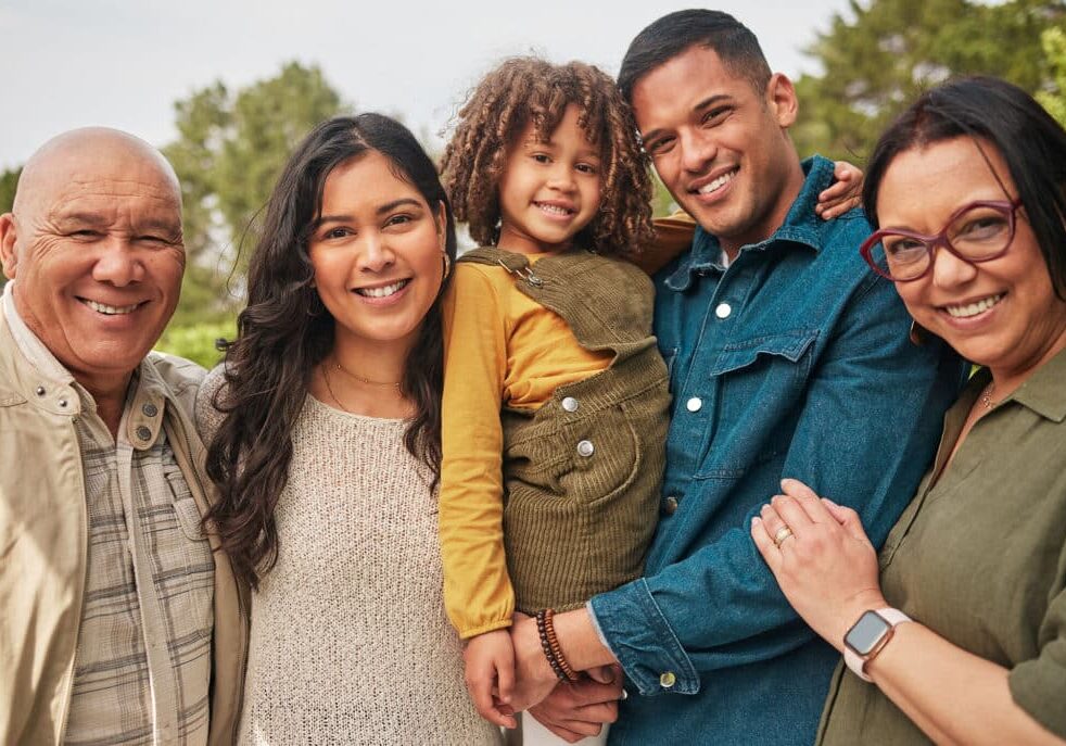 Happy family, grandparents and parent with kid in a park togethe
